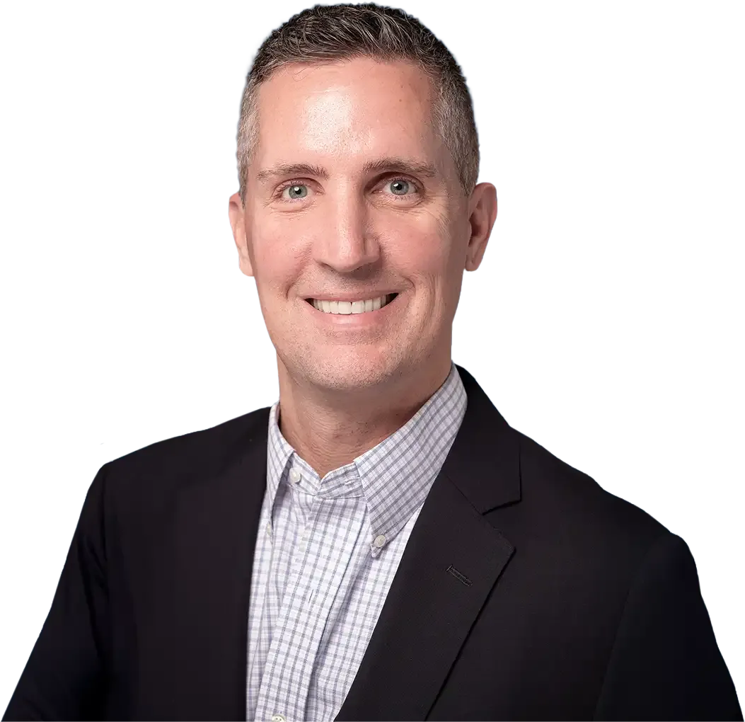 Ryan O'Connor smiling in a blazer and checkered shirt