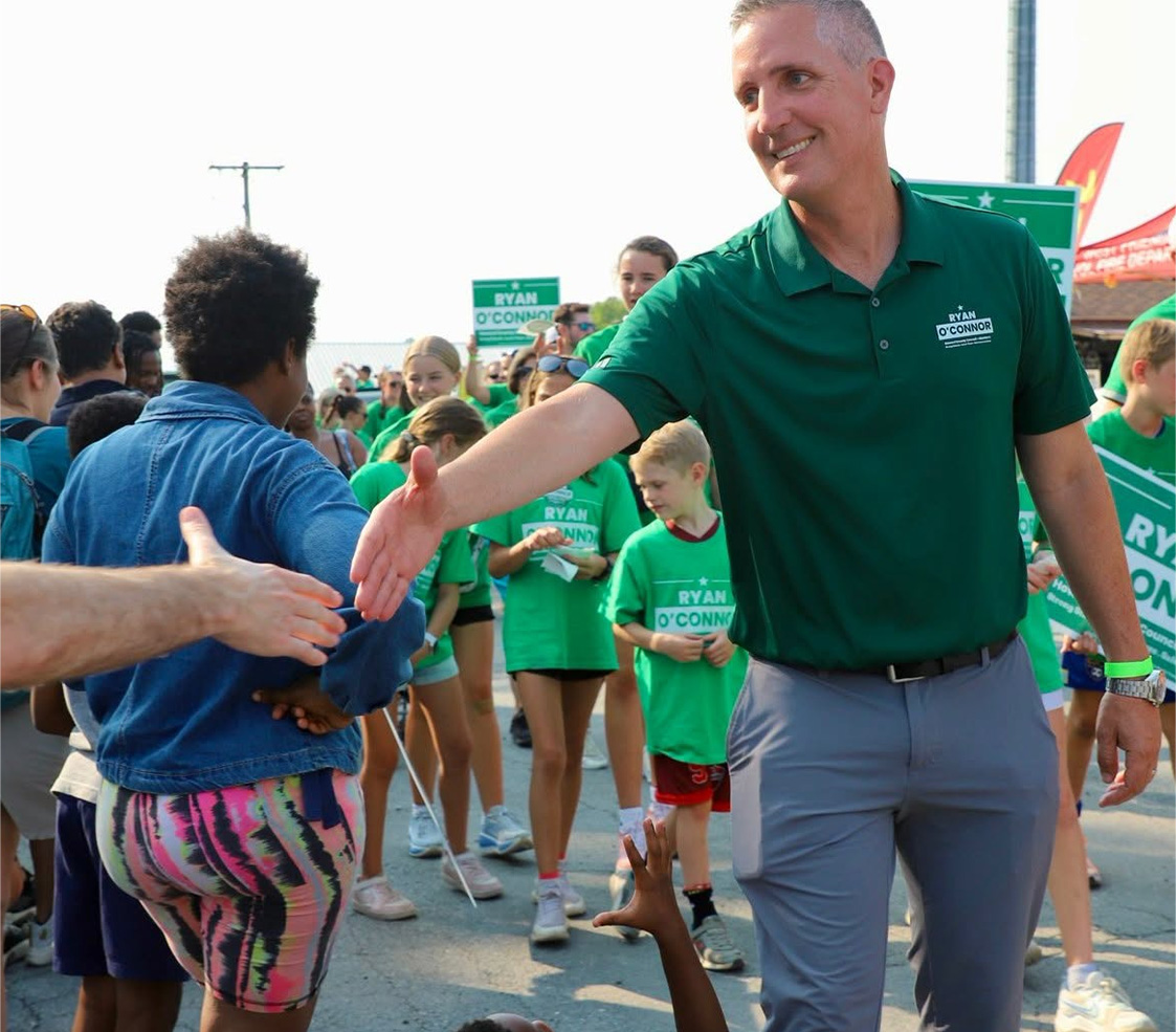 Ryan O’Connor shaking hands with a voter at an event